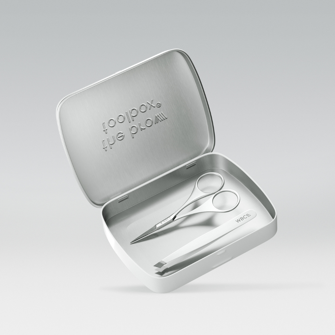 The Brow Toolbox tin with Scissors and tweezers and reusable tin.