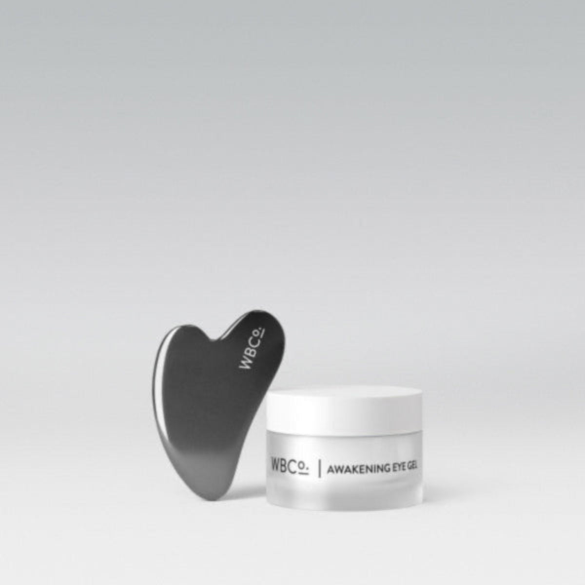 A jar of Awakening Eye Gel with an expensive Gua Sha tool.