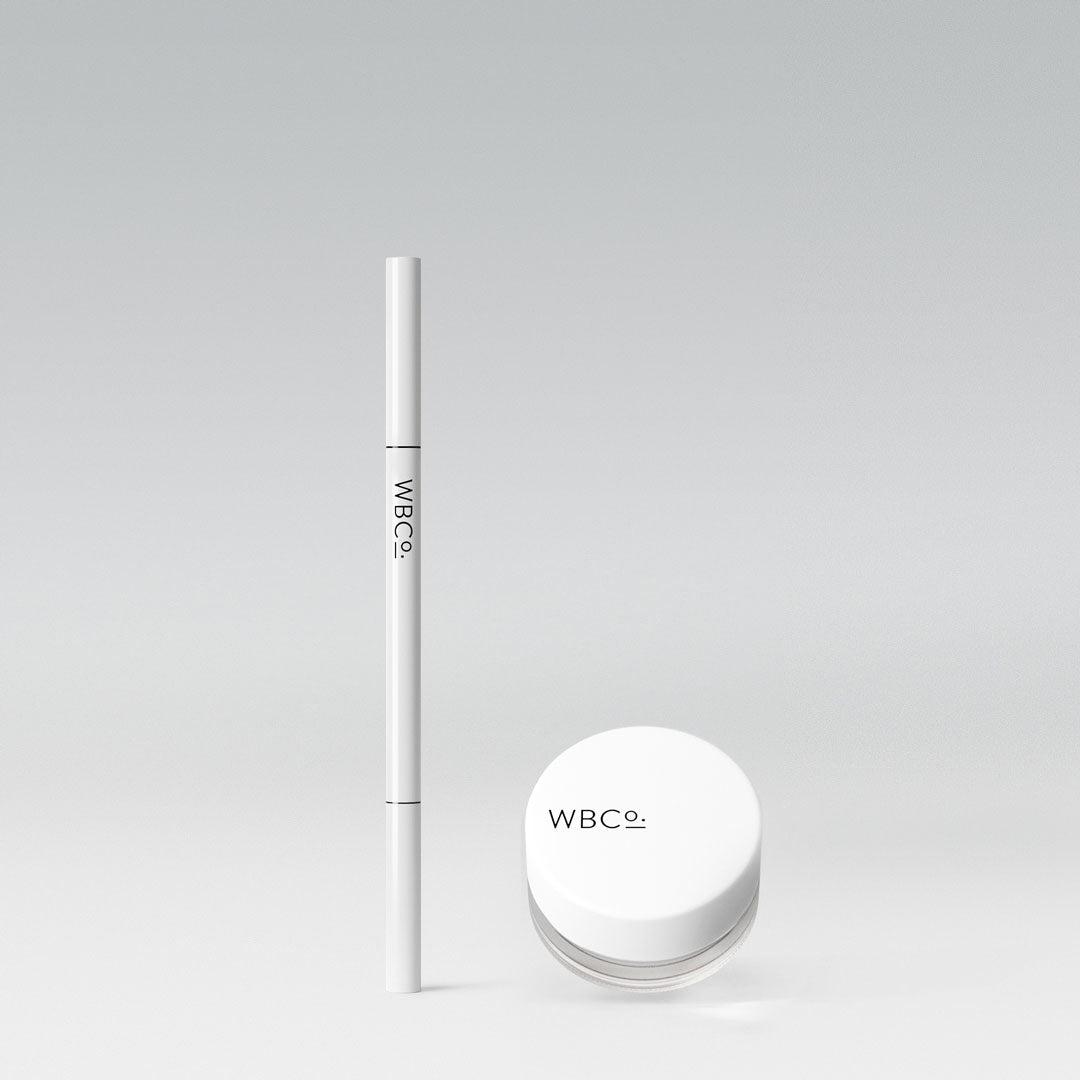 A white brow pomade container and a matching brow pencil against a grey background, both with the brand 'WBCO' printed on them.
