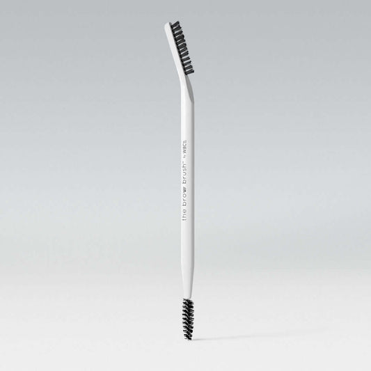 A dual-ended white brow brush with one spoolie end and one flat end for styling eyebrows. Trade marked for the unique shape. WBCo