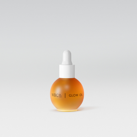A bottle of Glow Oil with a dropper cap, set against a white background. WBCo facial oil.